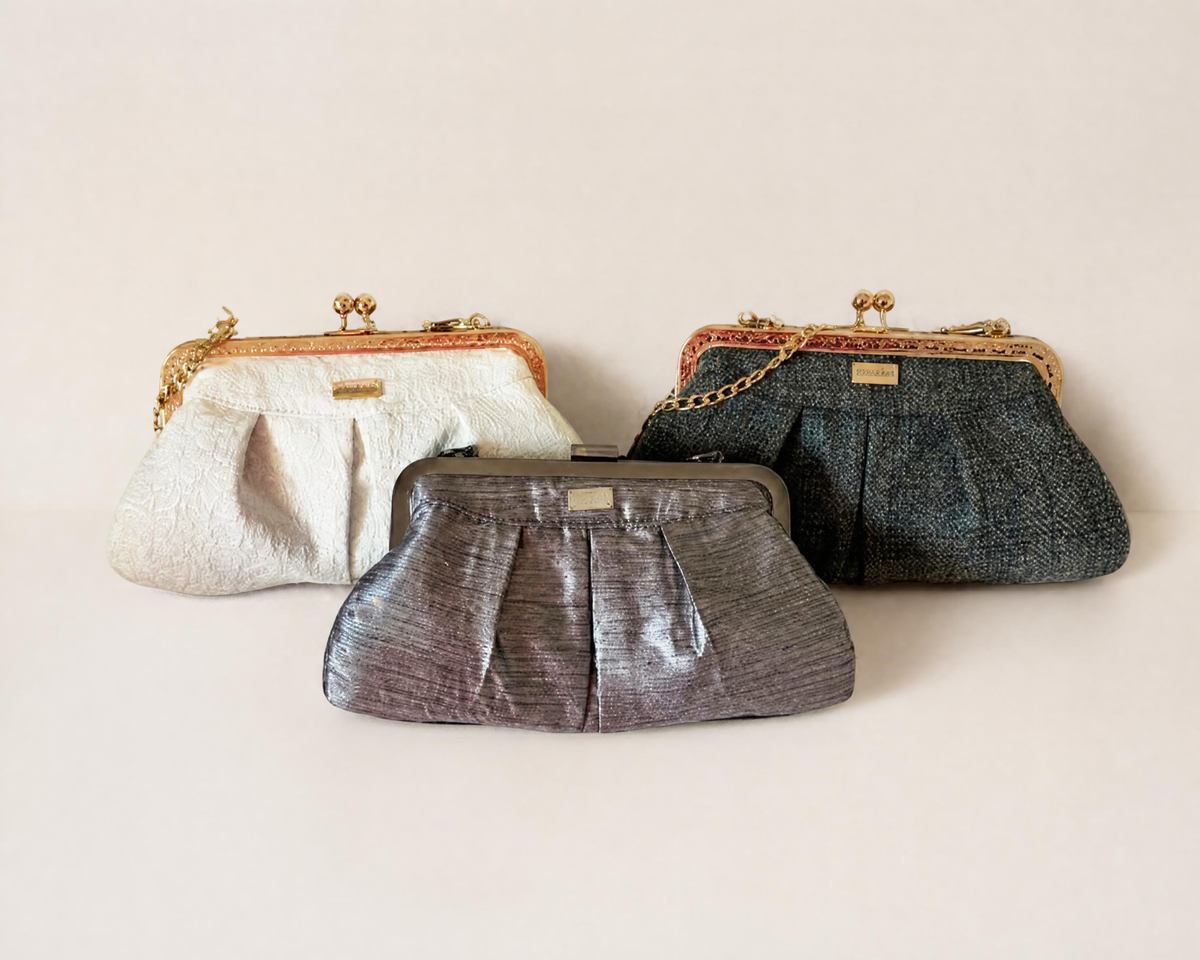 Three evening clutches on a clean cream background